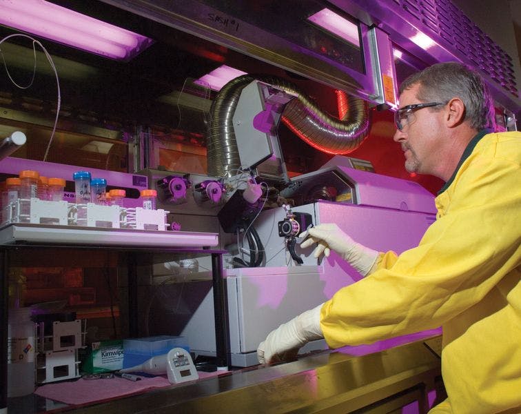 photo of worker at inductively coupled plasma-mass spectrometer