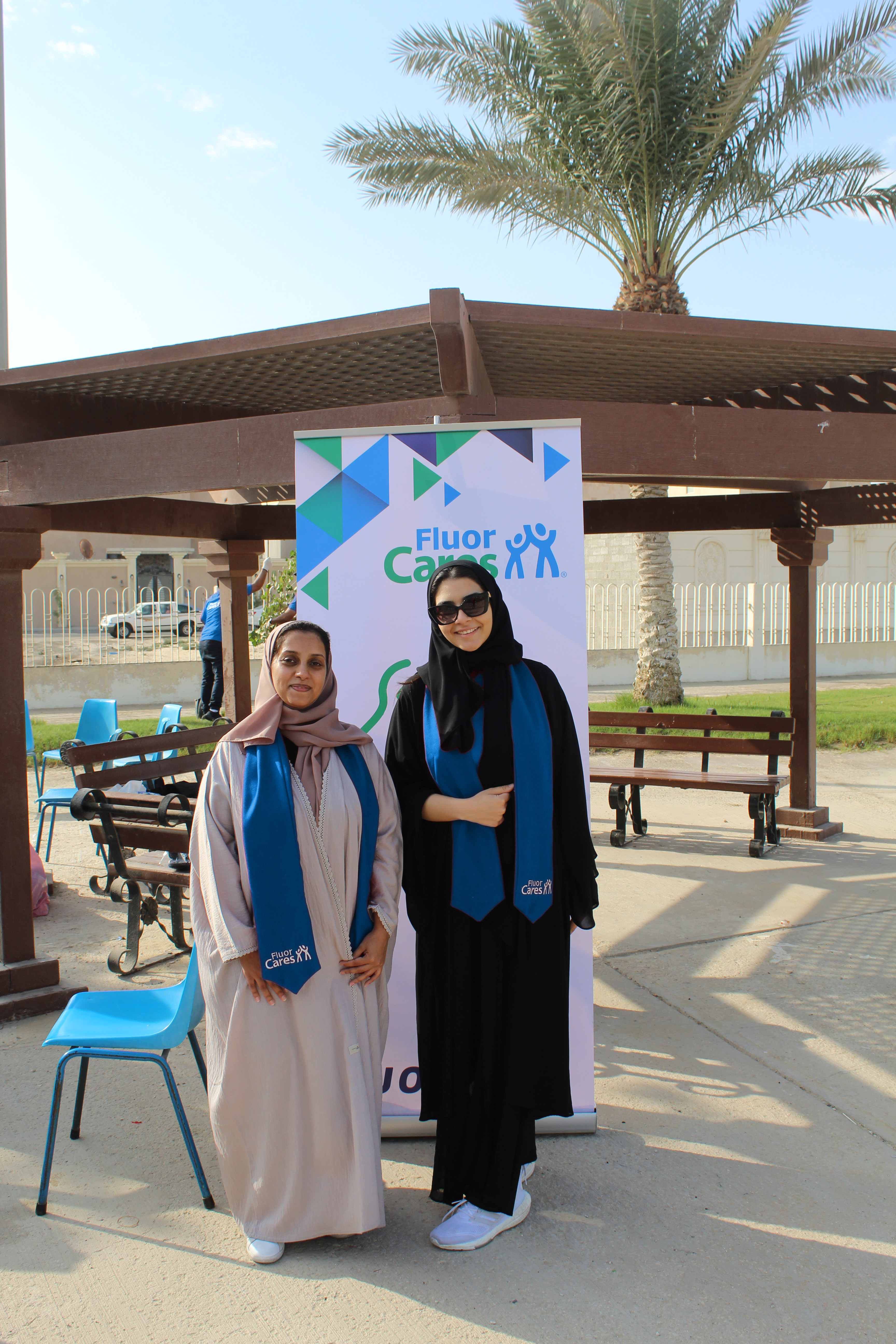 Two women in the Middle East with blue Fluor Cares scarves