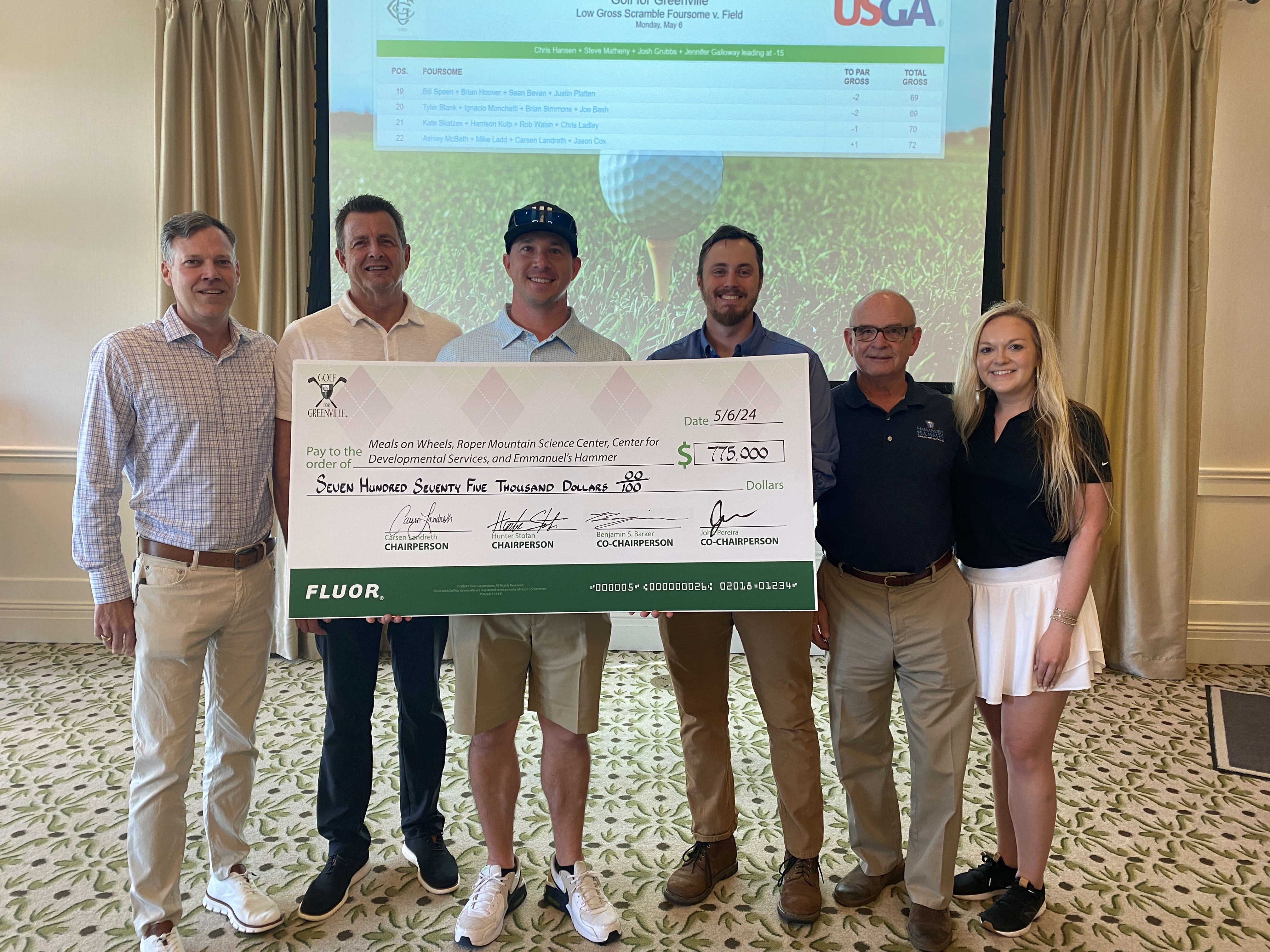 Group of Fluor employees with donation check from Golf for Greenville event